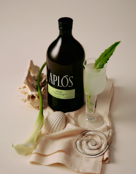 Bottle of Caplos with a glass and decorative elements on a neutral background