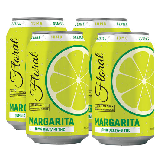 Four cans of Floral Margarita with lemon slices on a white background