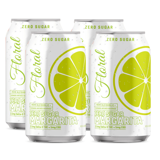 Four cans of 'Floral Zero Sugar Margarita' with lemon slices on a white background
