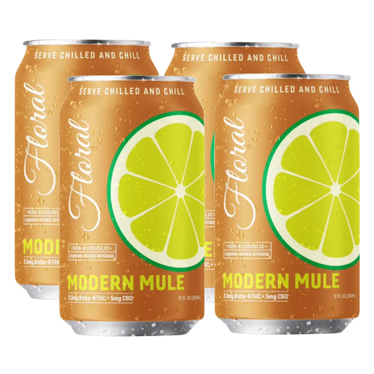Four cans of 'Floral' Modern Mule non-alcoholic beverage with lime slices on a white background.