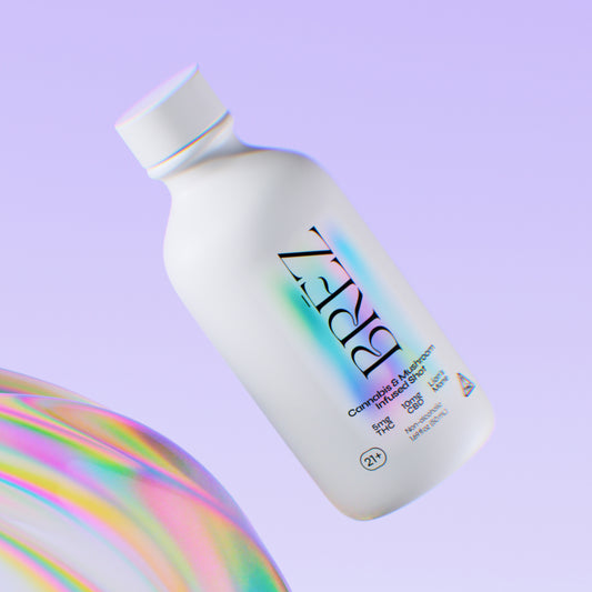 White bottle with colorful label on a light purple background